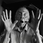 Shocked old man with hands up