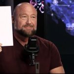 Alex Jones holds paper