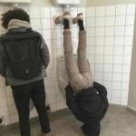 Man Upside Down at Urinal