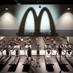 Anytime Fitness gym out side wall with a McDonalds logo shade on