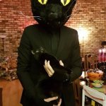 Black cat surprised by owner's costume