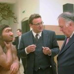 Neanderthal and two guys in a suit discussing