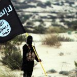 A Masked Democrat Hold's an ISIS Flag