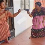 Two old women pointing guns