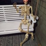 skeleton sitting on the bench