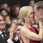 Kidman kissing Skarsgard while her husband cheers for them