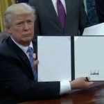 Donald Trump holding document