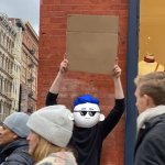 Codeblade holding a cardboard sign