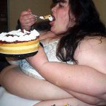 Fat woman eating a cake