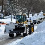 Excavator Removing Snow