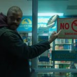 Ameer Vann pointing to the sign