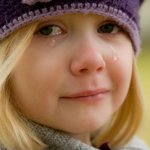 Crying little blond girl