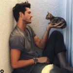 man with cat in hand