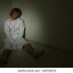Man Alone In Corner Of Room