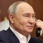 Putin smiling in the phone