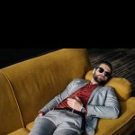Guy on couch with glasses. template