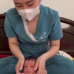 Nurse Sitting on Baby
