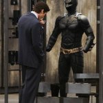 Batman looking at suit