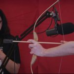 Nathan Drawfee pointing a bow at Karina Drawfee