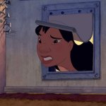Nani peeks through a dog door