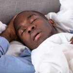Black man sleeping and dreaming