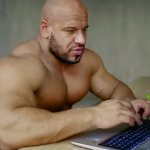 Strong man using laptop