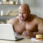 Strong man using laptop 2
