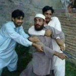 Two men holding back man with gun