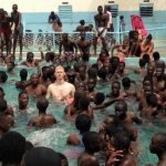 white guy in pool surrounded by blacks