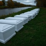 Children's coffins next to a river