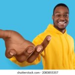 Black man holding something with open hand