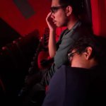 One guy sleeping one focused