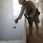 Marine throwing a grenade in Fallujah