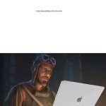 Nikolai looking at his laptop.