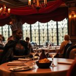 Black Queen at Restaurant Table