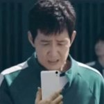 Seong Gi-Hun looking at his phone