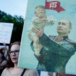 Woman protester Putin-Trump poster