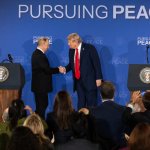 trump and putin shake hands