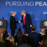 trump and putin shake hands
