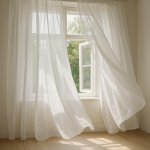 Diaphanous white curtains gently blowing in the breeze