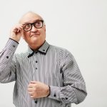 pENSIVE ELDERLY MAN WITH GLASSES LOOKING UP