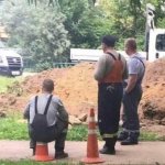 Worker sitting on traffic cone