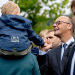 german Chancellor merz is talking to a toddler