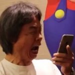 Shiguru Miyamoto looking at his phone
