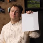 Shayne holds up painting