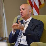 Jeff Bezos with microphone and flag