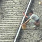 Indian man pooping on railway track