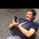 pedro pascal smiling at phone black