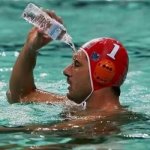 Pouring water on face in pool