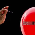 Needle pointing at a balloon